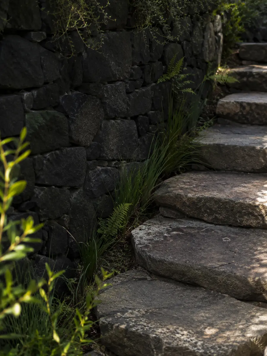 Weathered stone steps set into restrained planting